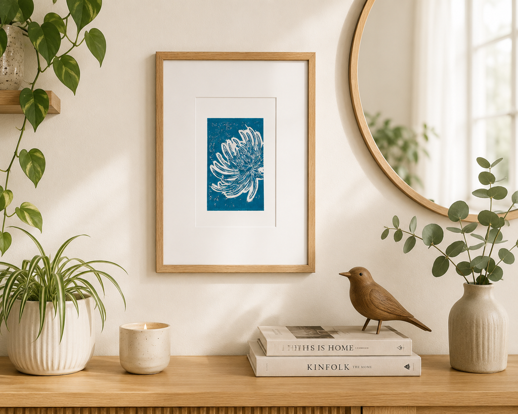 Turquoise chrysanthemum linocut print displayed in a modern Scandinavian home with natural wood furniture and houseplant