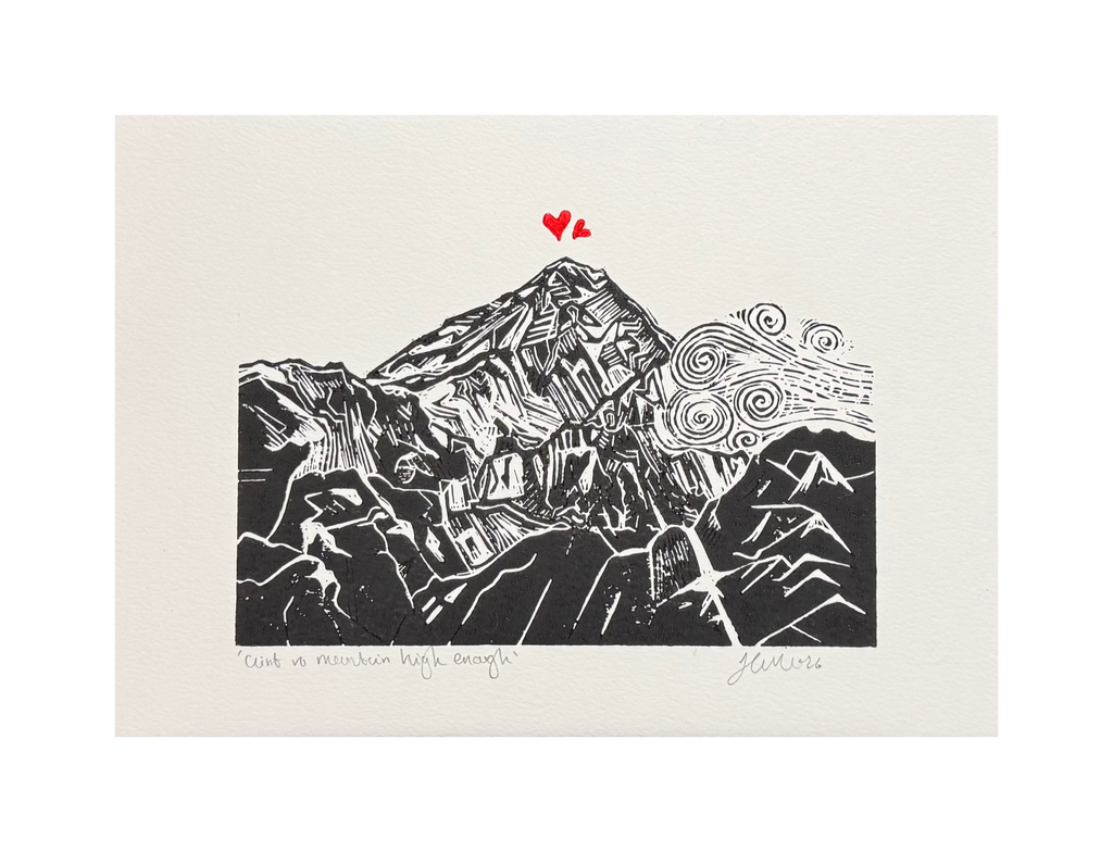 Handmade linocut mountain and love heart print, unframed, black and red ink on white textured paper, A4 size, overhead product shot