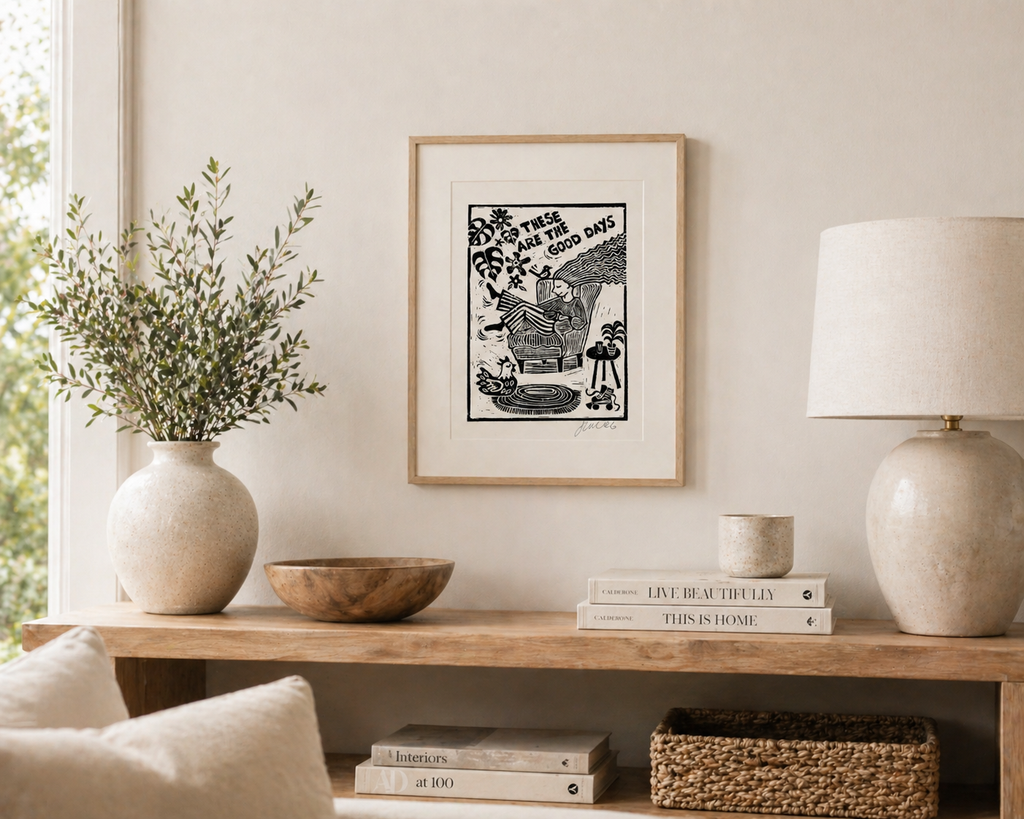 Living room shelf with decor items including a vase, books, and a framed picture.