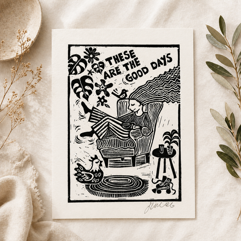 Black and white illustration of a person in a chair with text 'These are the good days' on a textured surface.