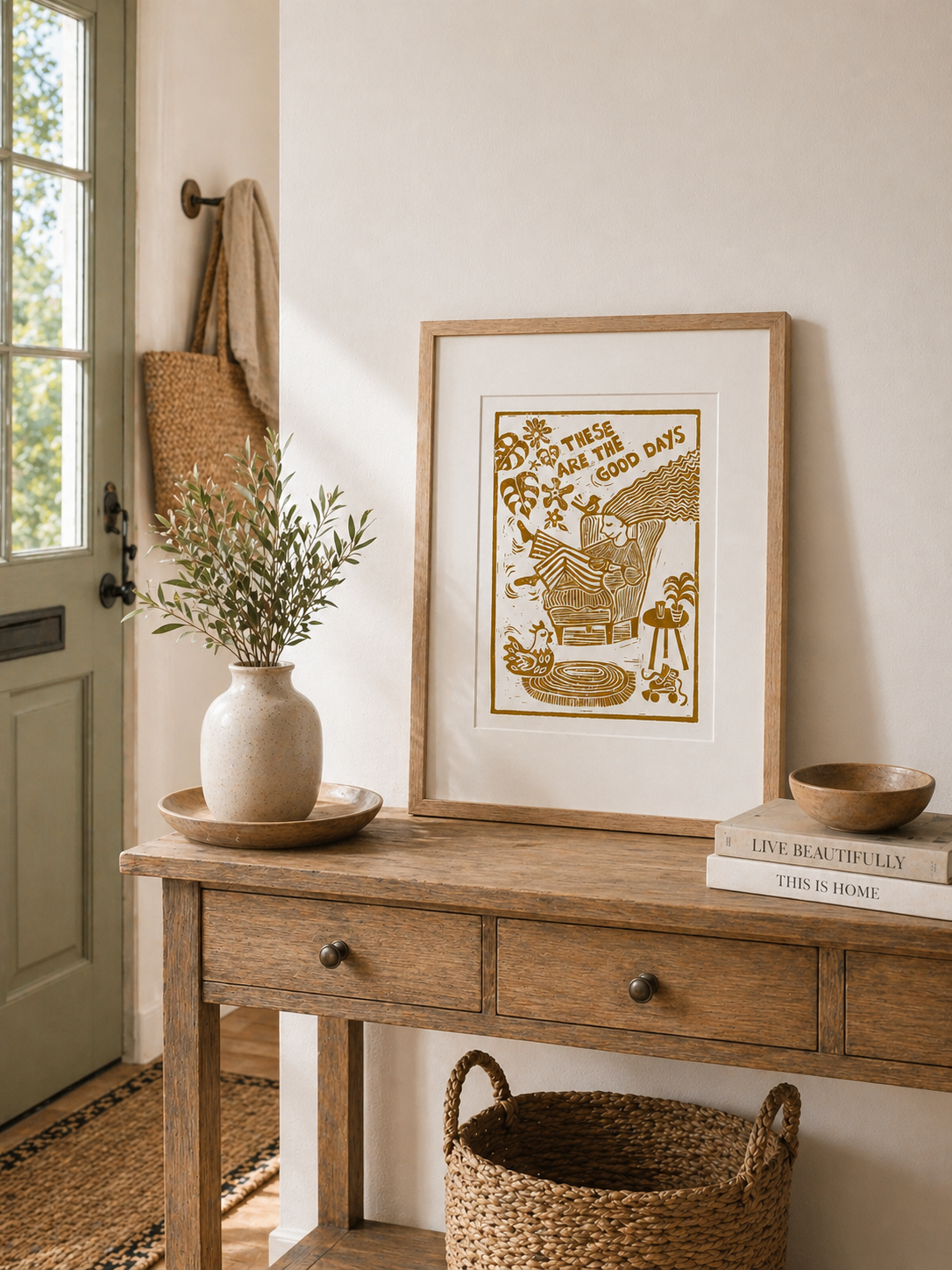 Nestled entryway with wooden console table, framed artwork, and decorative items.