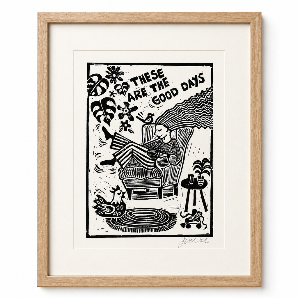 Framed black and white illustration with 'These Are The Good Days' text, featuring a person lounging on a chair.