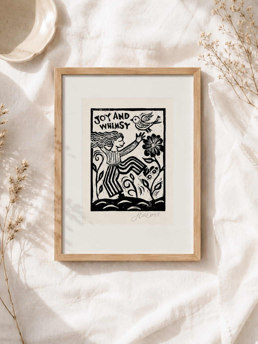 Framed artwork with a black and white illustration on a light background