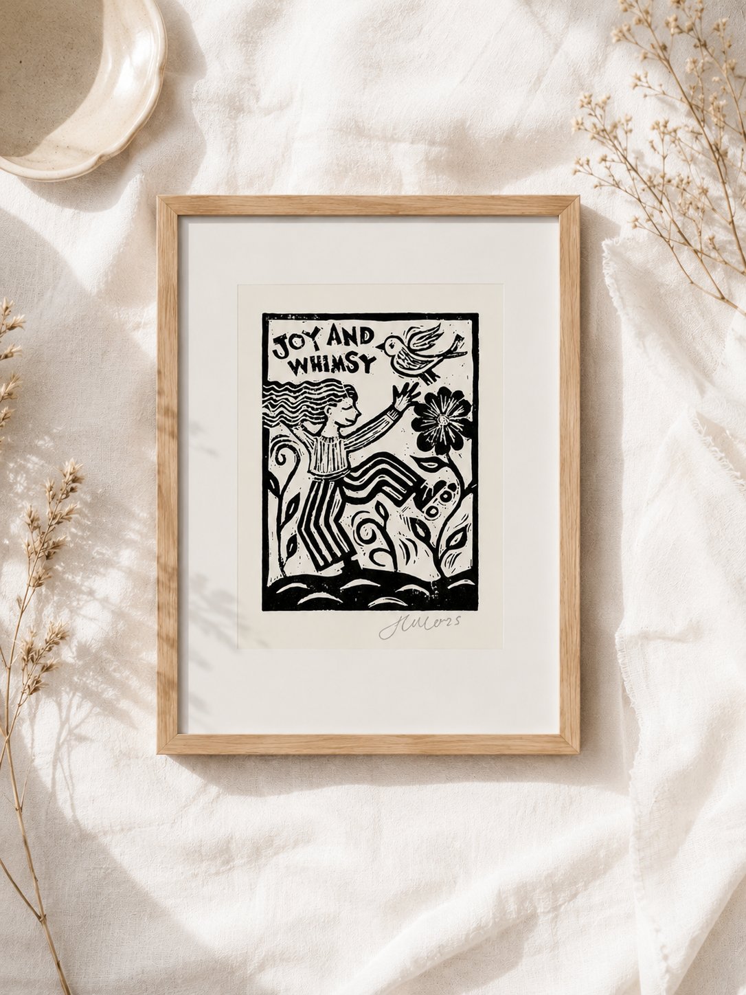 Framed artwork with a black and white illustration on a light background