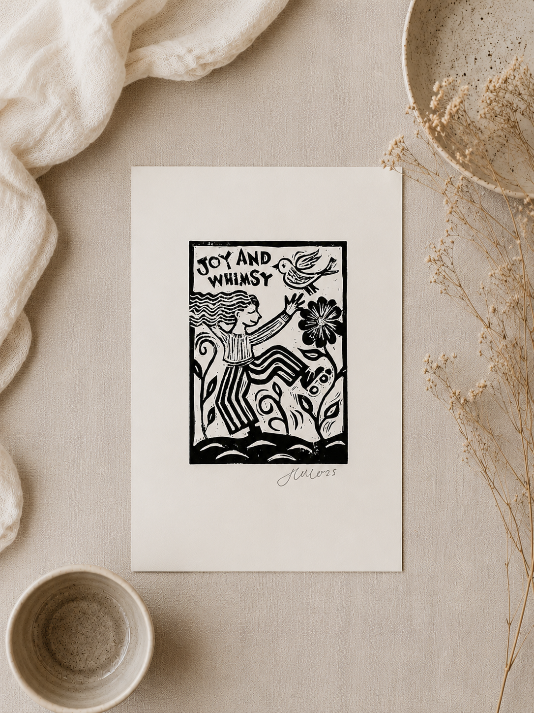 Black and white illustration on a white card with decorative elements on a beige surface