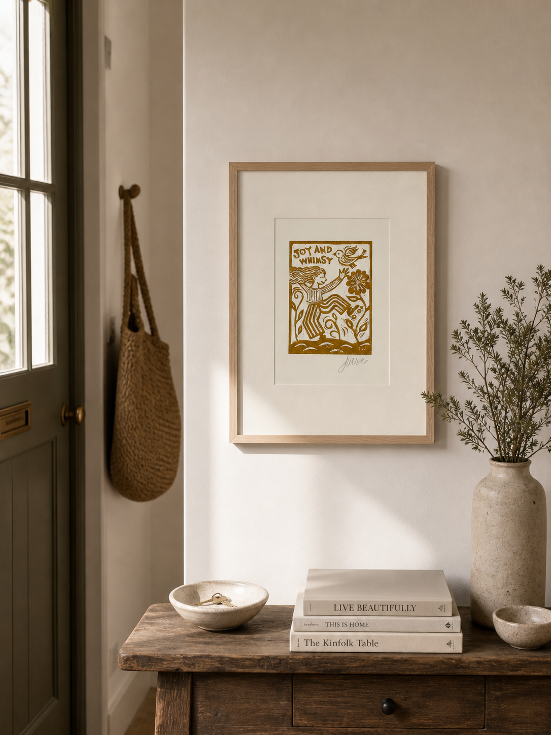 Nestled corner of a room with a framed print, books, and decorative items on a wooden surface.
