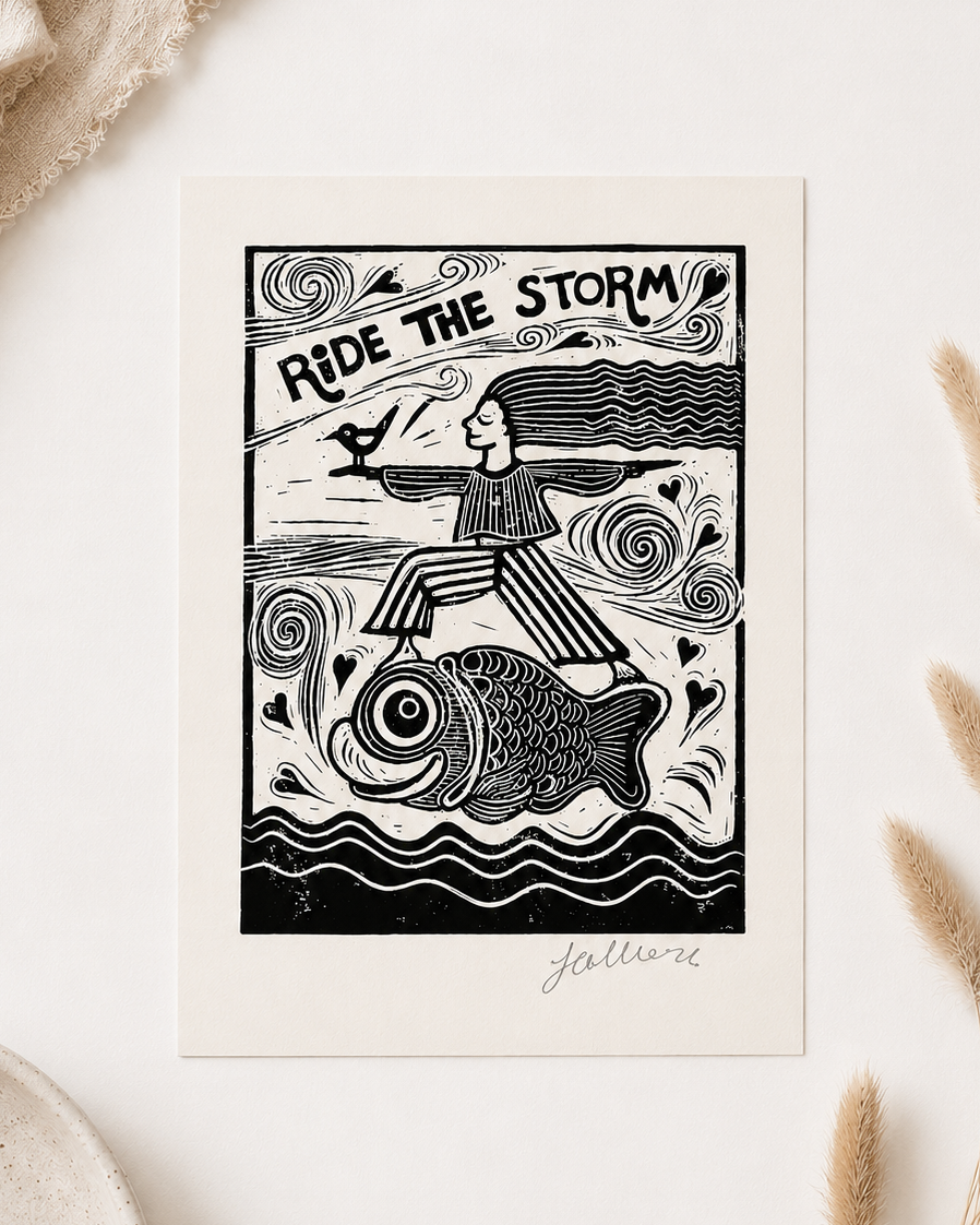 Framed artwork with a black and white illustration of a person riding a fish, surrounded by decorative elements on a light background.